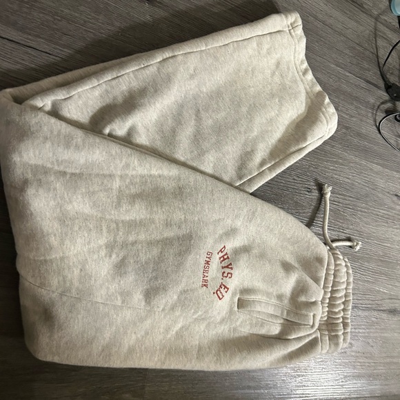 Gymshark Pants - Gymshark Phys. ED Beige Sweatpants with orange Print